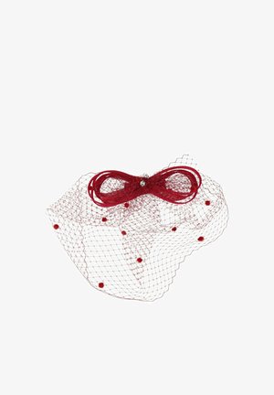 Red mesh fascinator with a bow and small pom-poms, featuring a central rhinestone detail, designed for decorative wear.