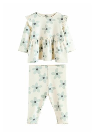 Barnoutfit med blommönster som har en långärmad topp med volanger på axlarna och matchande leggings, båda i ljusa färger och mjukt tyg.
