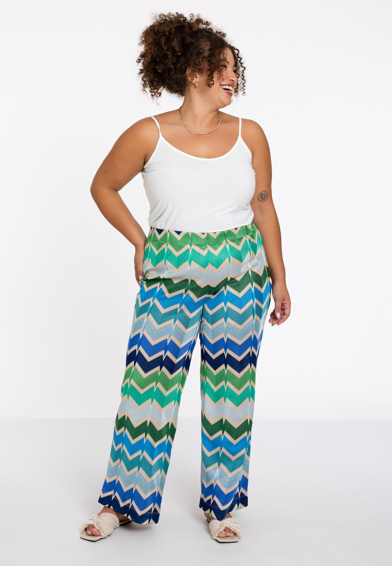 Wijde broek met een zigzagpatroon in groen, blauw en beige. Gemaakt van een lichte stof met een relaxte pasvorm.