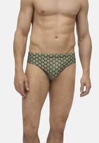 Bóxer de hombre de color verde con un patrón floral en rojo y blanco, con cinturilla elástica. Está fabricado con una tela suave y elástica.
