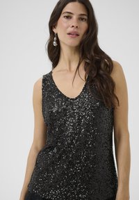 Black sequin tank top with a deep V-neck, featuring a fitted shape and smooth texture. Accentuated by shimmering sequins throughout.