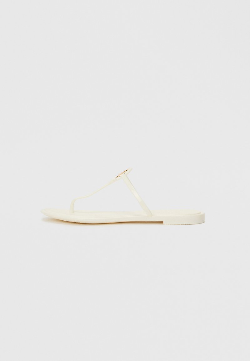 Flat thong sandals in pale yellow with a lightweight sole, featuring a simple design and a minimalistic gold accent.