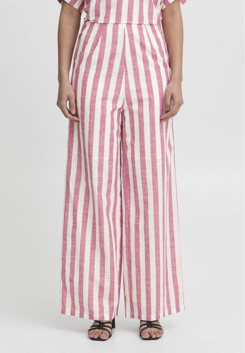 Pink and white striped wide-leg trousers, made of a light, textured fabric with a high waist and front pleats, paired with black sandals.