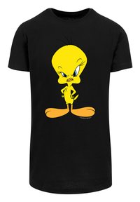 Černé bavlněné tričko s velkým, stylizovaným žlutým karikaturním charakterem s modrýma očima, výrazným zobákem a v stojící pozici.