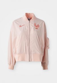 Pink bomber jacket made of smooth, lightweight material. Features a zip front, ribbed cuffs, and an embroidered rooster logo.
