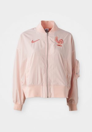 Casaco bomber rosa feito de material suave e leve. Apresenta fecho éclair na frente, punhos canelados e um logotipo de galo bordado.