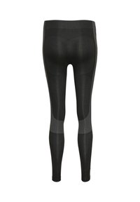 Sorte sømløse leggings set bagfra med teksturerede paneler på lårene og varierede strikkemønstre omkring læggene og linningen.