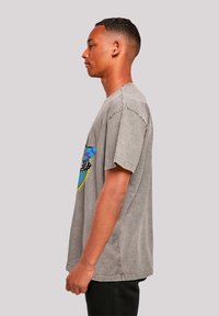 Gray cotton T-shirt featuring a multicolor graphic design on the front. Short sleeves, relaxed fit, and a slightly worn texture.
