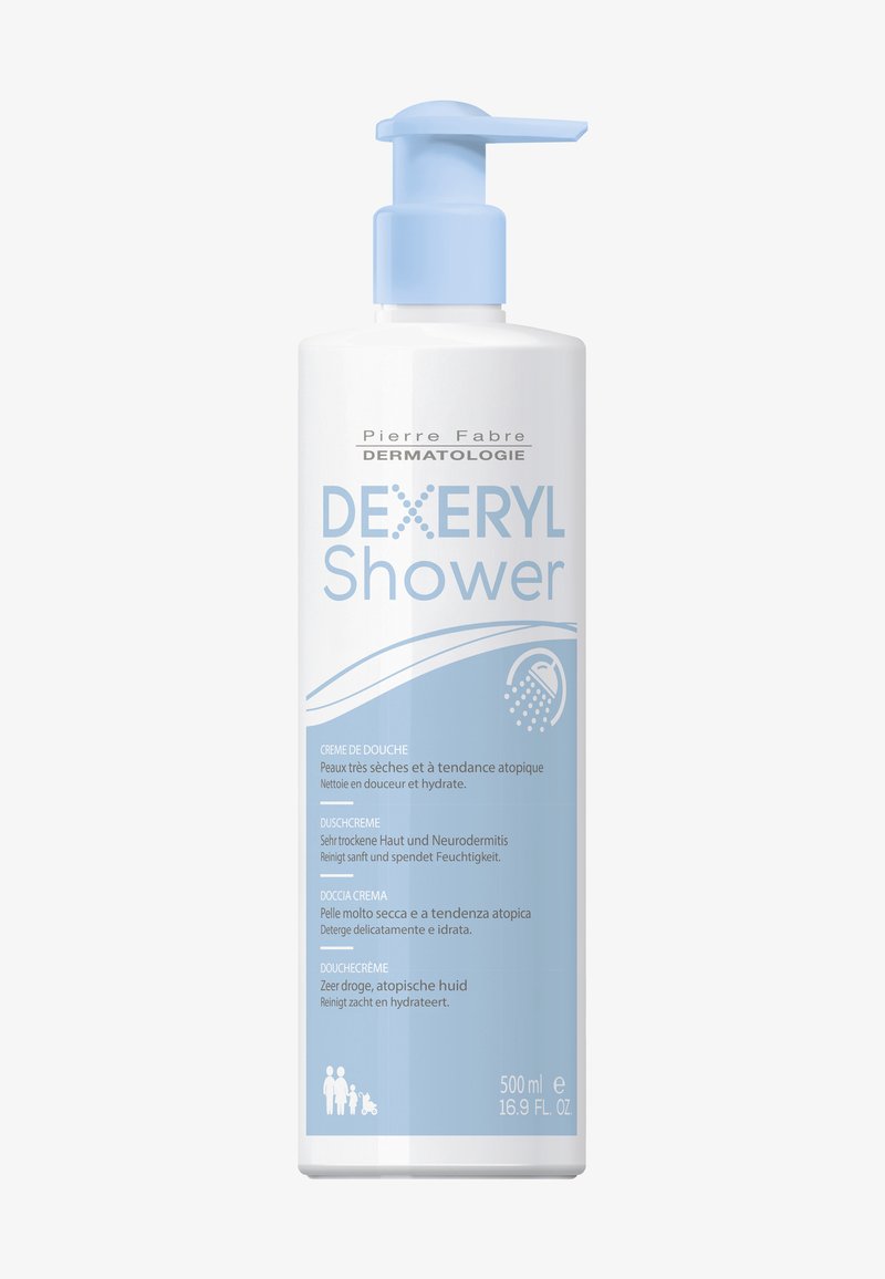 Dexeryl Duschcreme in einer 500 ml weißen Kunststoffpumpe. Mit blauen Akzenten und mehrsprachigem Text, der auf die Hydratation für sehr trockene Haut hinweist.