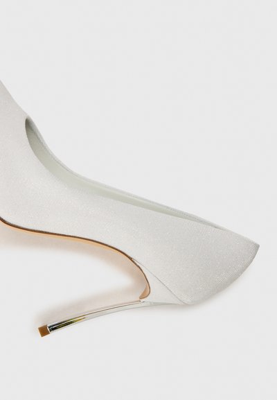White high-heeled pump with a shimmery texture, sleek pointed toe, curved silhouette, and a metallic silver heel accent.