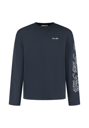 Navy long-sleeve t-shirt made of soft fabric. Features a crew neck and white text design on the left chest and along the right sleeve.
