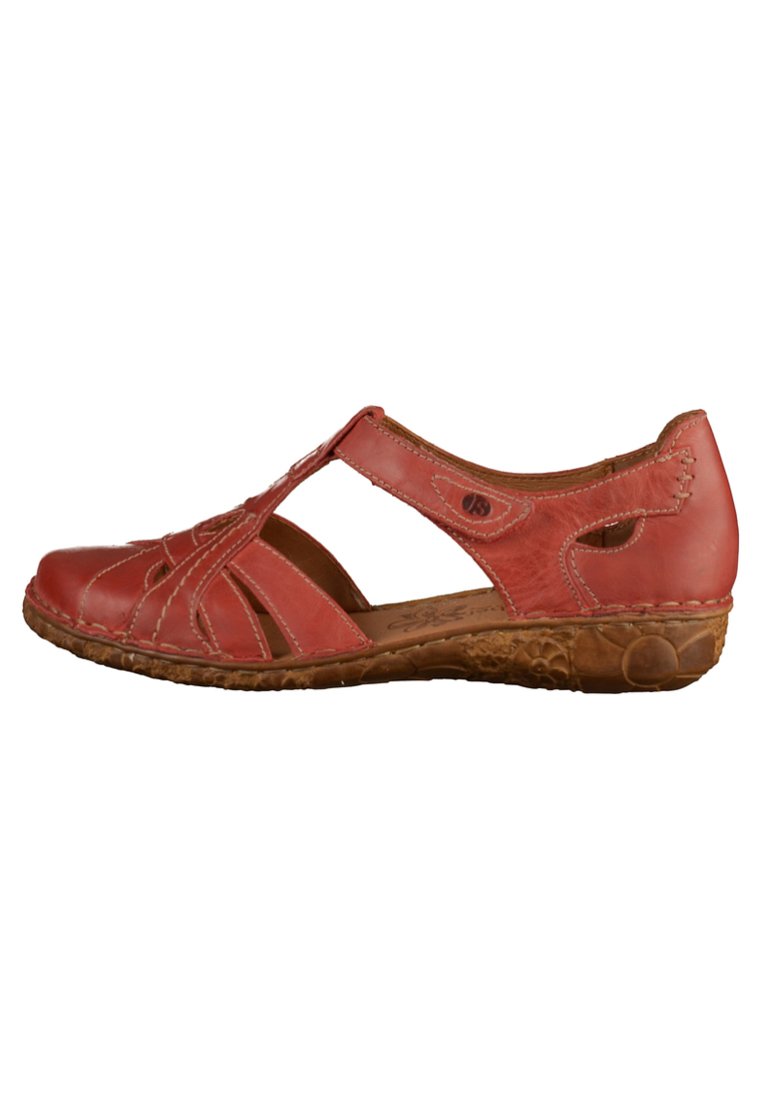 Red leather sandal with open sides, decorative cutouts, and stitching details. Features a textured brown sole for added grip.