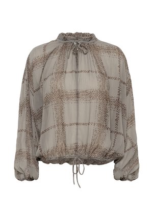 Blouse ample beige avec motif à carreaux marron à pois, encolure froncée avec lien, manches longues bouffantes et ourlet à cordon ajustable.