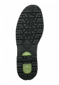 Semelle de chaussure en caoutchouc noir avec un motif de semelle profonde, une surface texturée et un insert circulaire vert amortissant aux talons.
