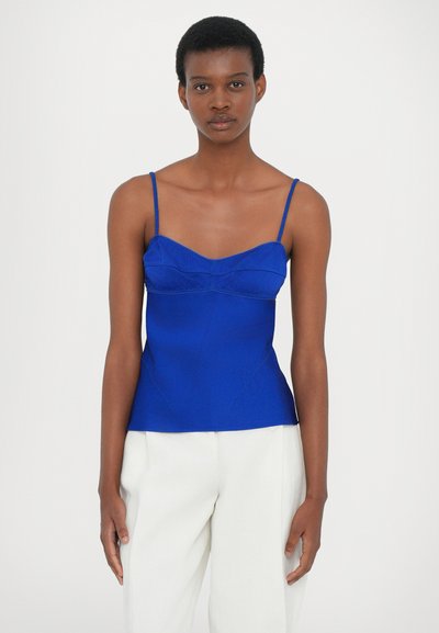 Canotta blu royal con spalline regolabili, caratterizzata da un collo a cuore e cuciture testurizzate su una silhouette aderente.
