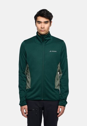 Groene zip-up jas met een hoge kraag, contrasterende lichtgrijze zijpanelen en textielstructuur. Beschikt over een Vaude-logo op de borst.