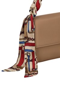 Beige nahkainen käsilaukku, jossa punaisen, sinisen ja beigen sävyinen punottu kuvioitu huivi. Laukulla on jämäkkä muoto ja sileä pinta.