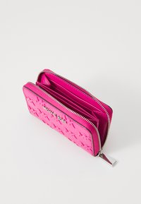 Pink leather wallet featuring a textured design with a zip closure, multiple card slots, and a silver logo accent.