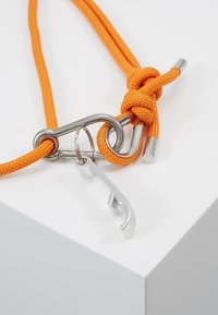 Orange braided rope with a stainless steel carabiner and a silver multi-tool keychain, featuring a curved hook shape and a decorative knot.