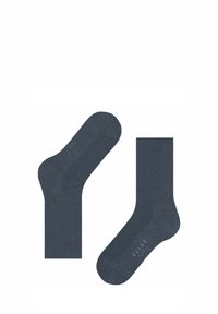 Chaussettes en mélange de coton bleu foncé, présentant une section supérieure côtelée et une texture lisse, avec le texte de la marque "FALKE" visible sur le pied.