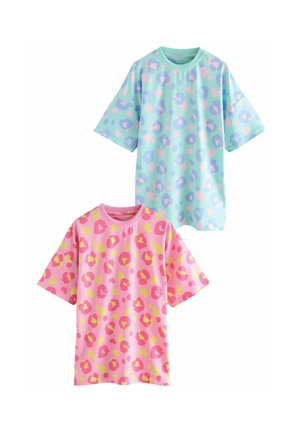 Two short-sleeved T-shirts: one mint green with purple and pink leopard spots, the other pink with yellow and darker pink spots.