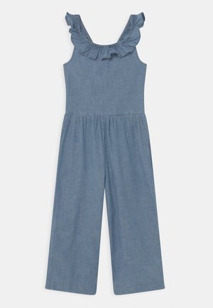 Combinaison bleue sans manches avec un col à volants et un pantalon ample, fabriquée en tissu léger.