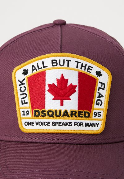 Maroon cap with a rectangular patch. The patch features a Canadian flag design, bold text, and embroidery in yellow, red, and black.