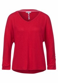 Rotes Langarmoberteil mit V-Ausschnitt, aus weichem Material. Hat einen lässigen Schnitt und geraffte Details an den Ärmeln. Leicht abgerundeter Saum.
