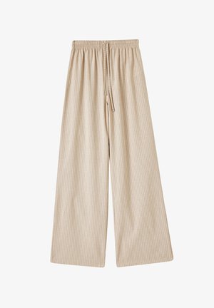 Beige wijde broek met een elastische tailleband en trekkoord, voorzien van verticale witte strepen en een soepele stofstructuur.