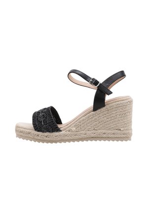 Sandalia cuña negra con tira delantera tejida, correa de hebilla en el tobillo y suela de esparto trenzada en beige.