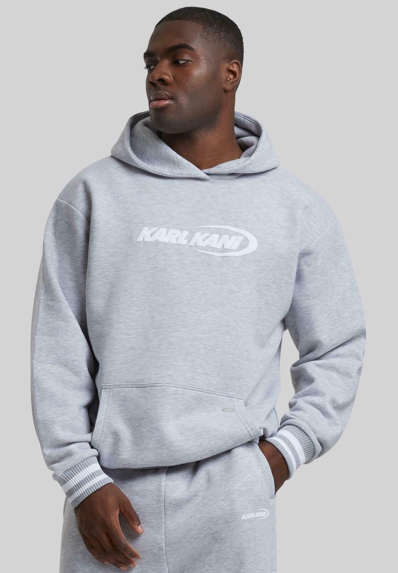 Gray hooded sweatshirt featuring a front pocket, ribbed cuffs, and a white "KARL KANI" logo across the chest. Soft cotton fabric.