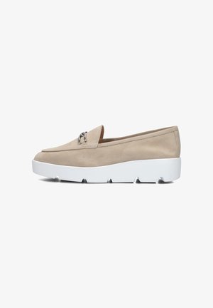 Beige suede slip-on shoe with a rounded toe, featuring a small silver hardware accent, and a chunky white rubber sole with visible tread.
