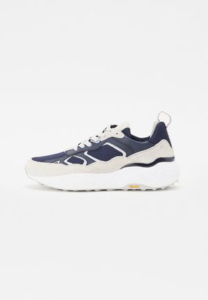 Navy mesh and gray suede sneaker with white outsole, featuring accent details and a textured finish. Vibram logo on the sole.