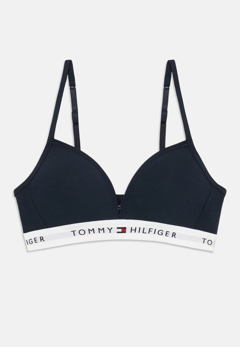 Tmavomodrá bezdrôtová podprsenka s nastaviteľnými ramienkami a bielym elastickým pásom s logom a vlajkovým emblemom Tommy Hilfiger.
