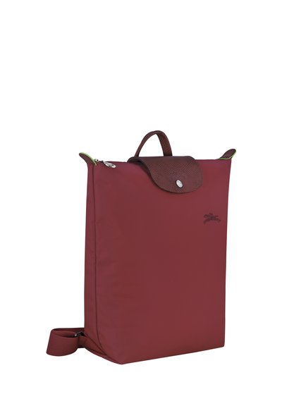 Burgundy backpack made of nylon with a textured brown flap, green zipper, and adjustable strap. Features a handle on top for easy carrying.