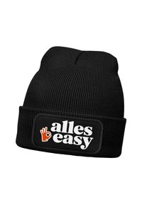 Black knitted beanie hat with a folded cuff. Features a rectangular patch displaying "alles easy" in white and orange text, with a hand graphic.