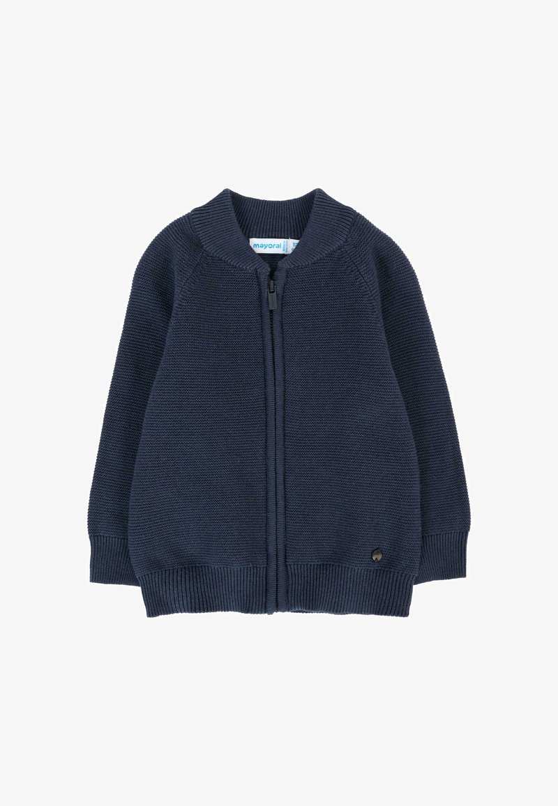 Gilet en maille bleu marine avec un col rond, fermeture éclair et poignets côtelés. Présente une petite étiquette de logo en bas à gauche.