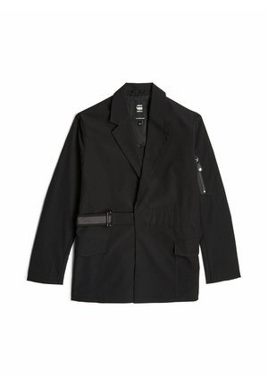 Black blazer made of smooth fabric, featuring a belted waist, two front pockets, and a zippered pocket on the sleeve.