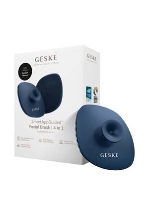 Geske 4-i-1 navyblå silikone ansigtsbørste med sugekop, vist sammen med sin hvide æskeemballage, der fremhæver nøglefunktioner og priser.