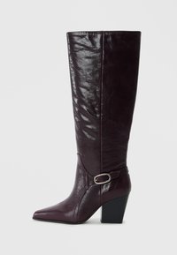 Burgundy leather knee-high boots with a pointed toe, textured finish, and a block heel. Features a strap with a silver buckle accent.