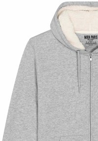 Felpa grigia con zip, dotata di un morbido rivestimento in pile color crema, cordini regolabili e tasca a marsupio frontale.