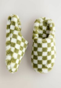 Green and white checkered fuzzy slippers with a soft texture; rounded shape and open back for easy wear.