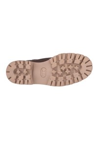 Sole marrone con ispessimenti pronunciati, realizzata in materiale di gomma beige; logo impresso al centro; design complessivo robusto.