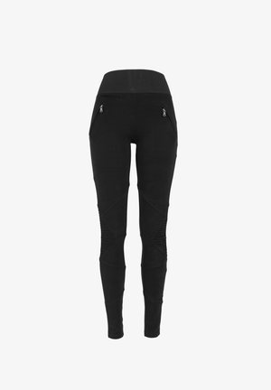 Schwarze Leggings mit einem breiten Bund, die zwei mit Reißverschluss versehenen vorderen Taschen und strukturierte Akzente an den Seiten für zusätzliche Details aufweisen.