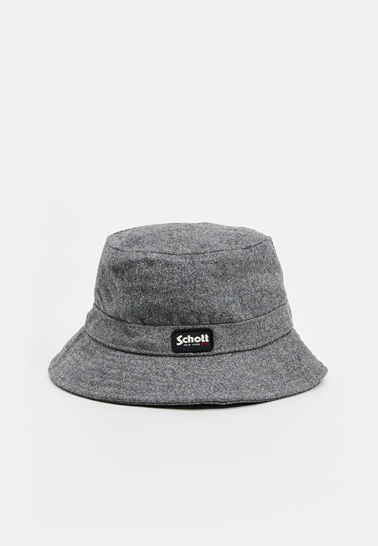 Cappello a secchiello grigio realizzato in morbido feltro. Presenta una larga visiera curvata verso il basso e una fascia attorno alla corona con un'etichetta nera.