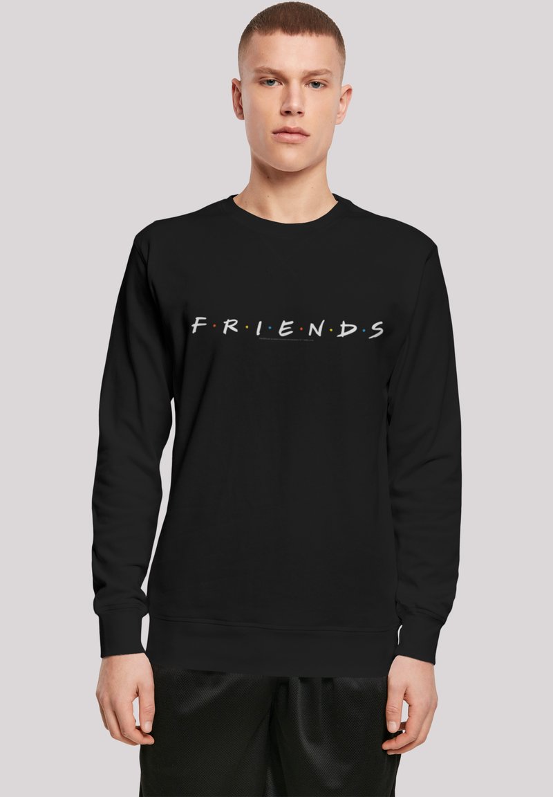 Svart hettegenser med ordet "FRIENDS" i hvitt og fargerike prikker, laget av bomullsblanding, med rund hals og ribbestrikkede ermer.