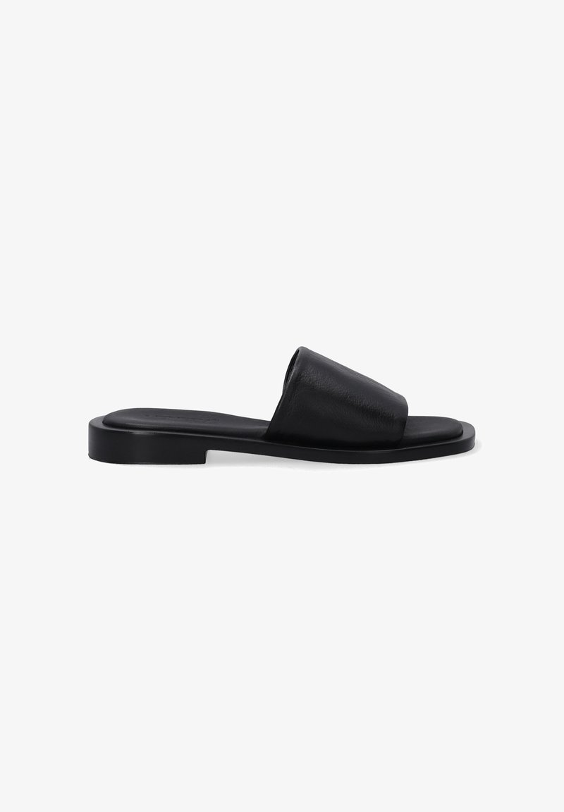 Black leather slide sandal with a wide upper band and flat rubber sole, featuring a smooth texture and minimalistic design.