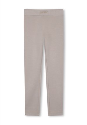 Leggings beiges longueur totale avec logo DKNY sur la ceinture élastique, design uni et texture lisse.