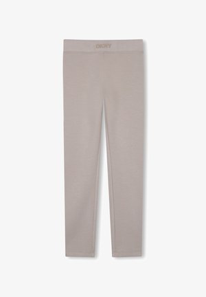 Leggings beige de larga duración con logo DKNY en la cintura elástica, diseño liso y textura suave.