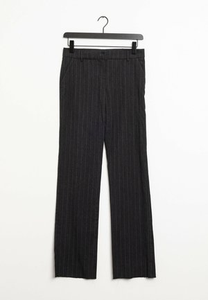 Black pinstripe tailored trousers with front pockets, belt loops, and a straight-leg cut hanging on a black clip hanger against a white background.